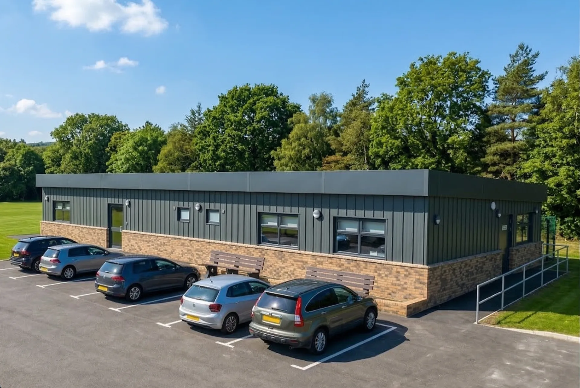Grey Modular Office Building with Car Park and Accessibility Ramp
